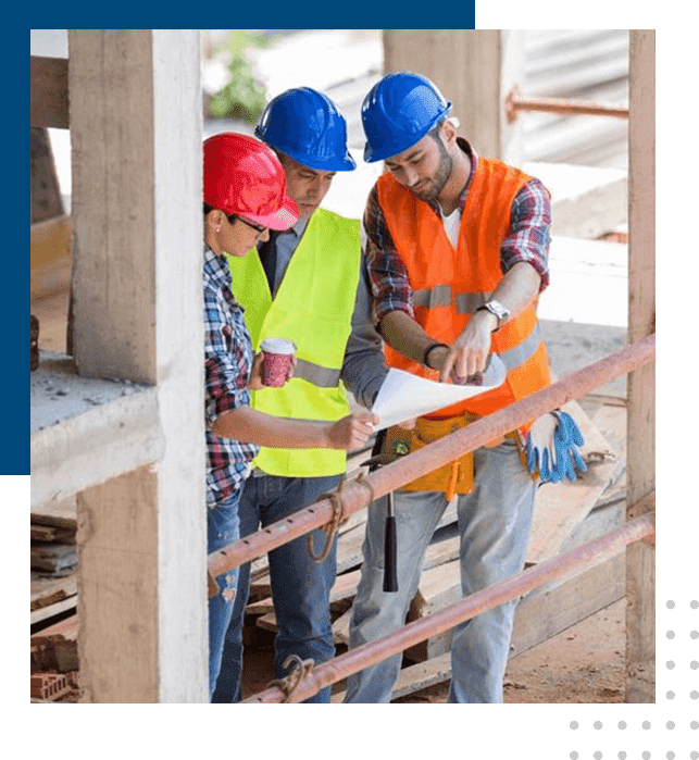 Three construction workers wearing hard hats and vests.