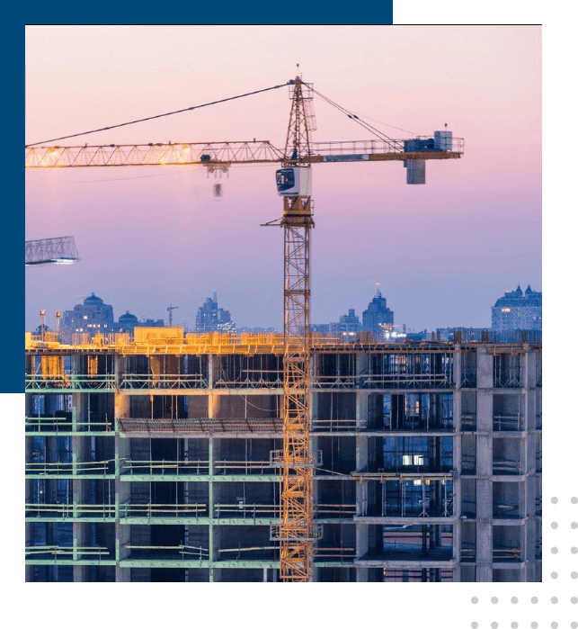 A crane is in front of a building under construction.